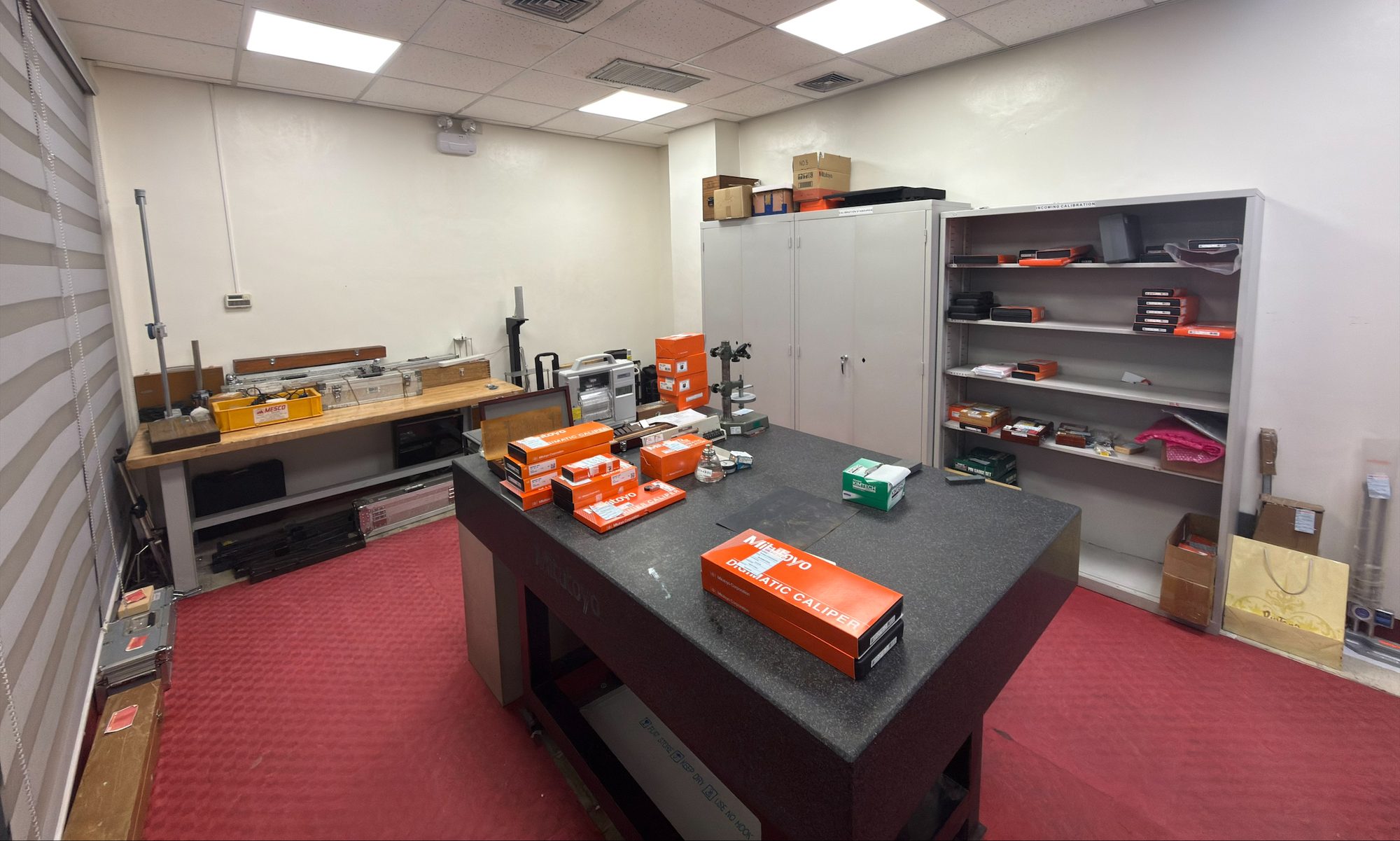 The MESCO calibration lab, with a granite surface table and shelves of instruments awaiting calibration